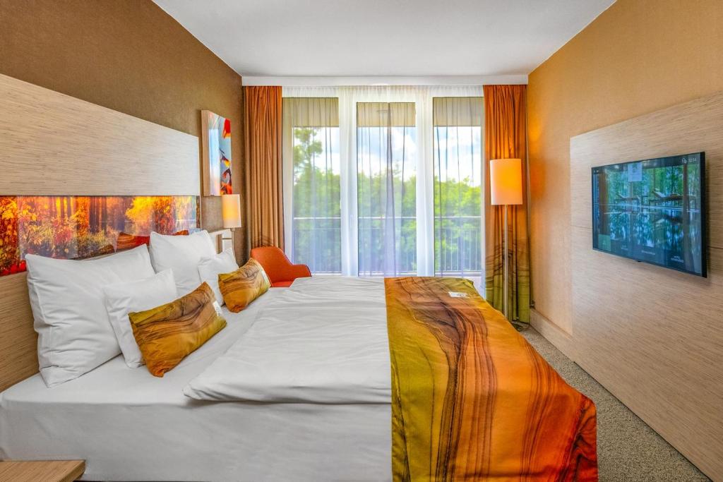 Postel nebo postele na pokoji v ubytování Lifestyle Hotel Mátra