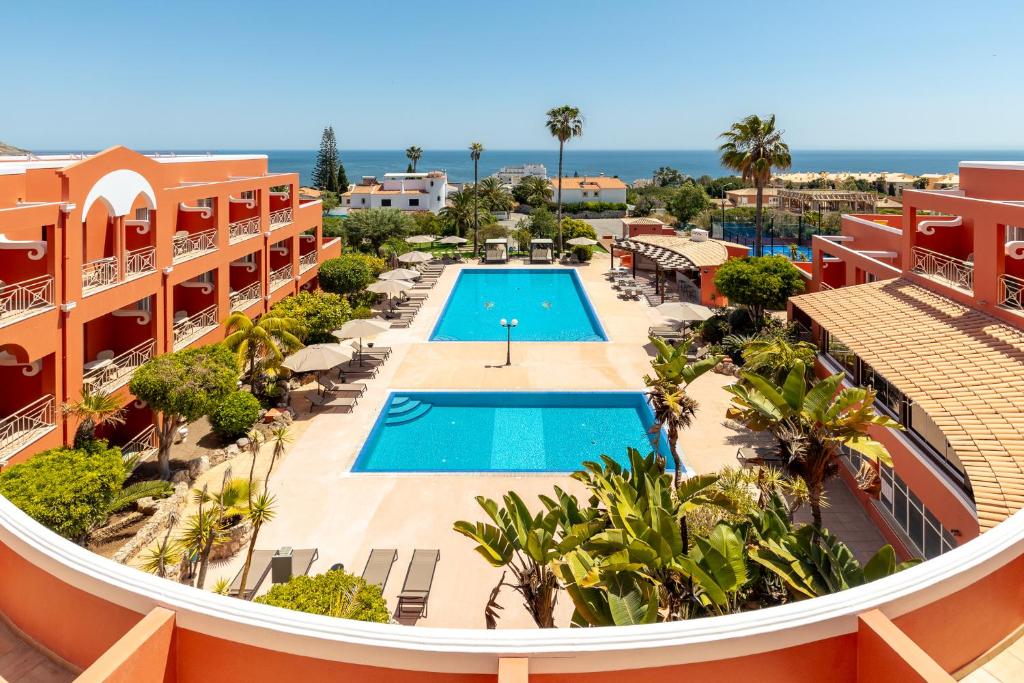 an aerial view of a resort with a swimming pool at Belavista Da Luz - Wellness & Lifestyle Hotel in Luz