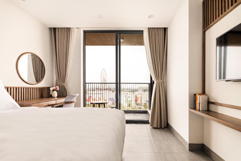 Postel nebo postele na pokoji v ubytování Hoàng Thịnh Hotel & Apartment Danang