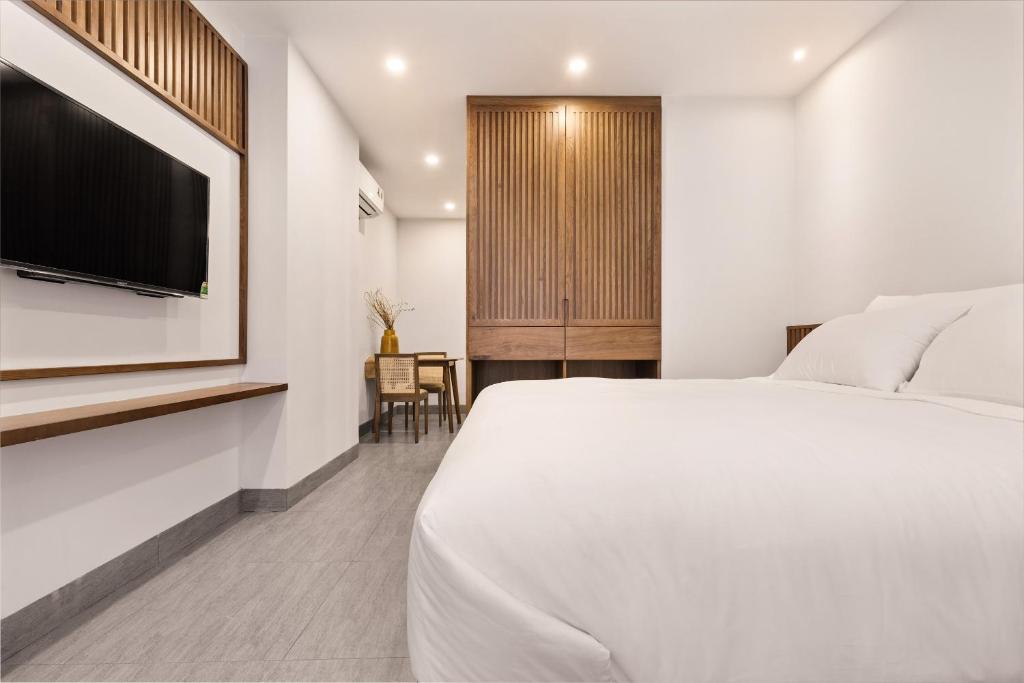 Postel nebo postele na pokoji v ubytování Hoàng Thịnh Hotel & Apartment Danang