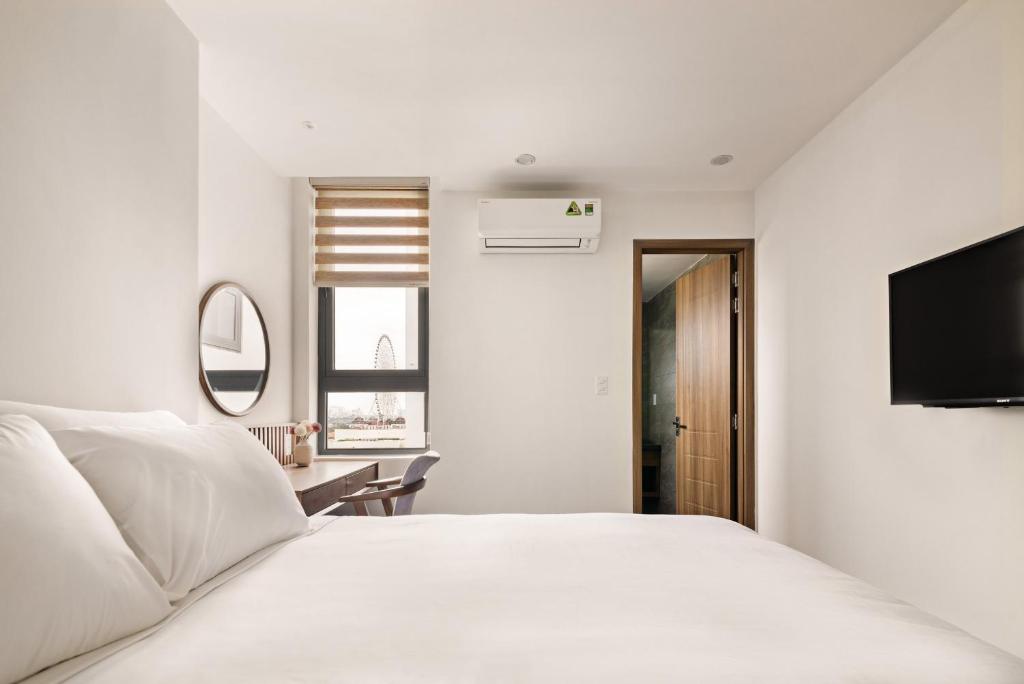Postel nebo postele na pokoji v ubytování Hoàng Thịnh Hotel & Apartment Danang