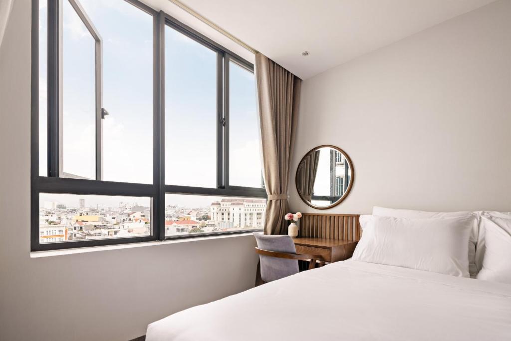 Postel nebo postele na pokoji v ubytování Hoàng Thịnh Hotel & Apartment Danang