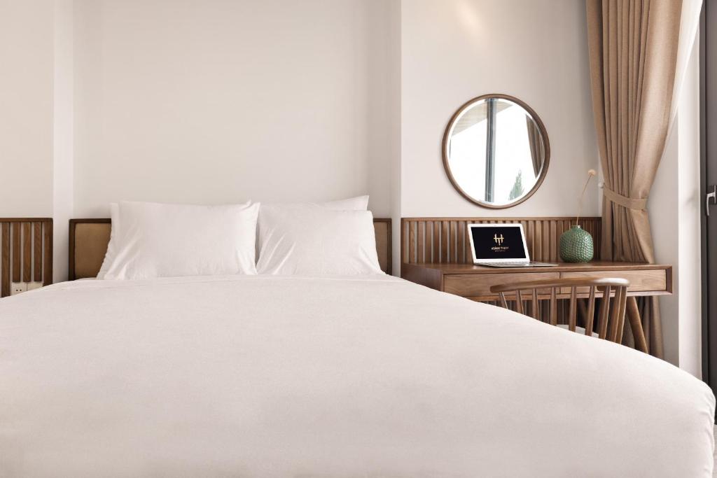Postel nebo postele na pokoji v ubytování Hoàng Thịnh Hotel & Apartment Danang
