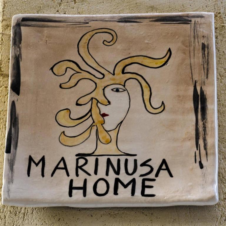 a sign on a wall with a picture of a woman at Marinusa home luxury - air conditioned - wi-fi in Syracuse