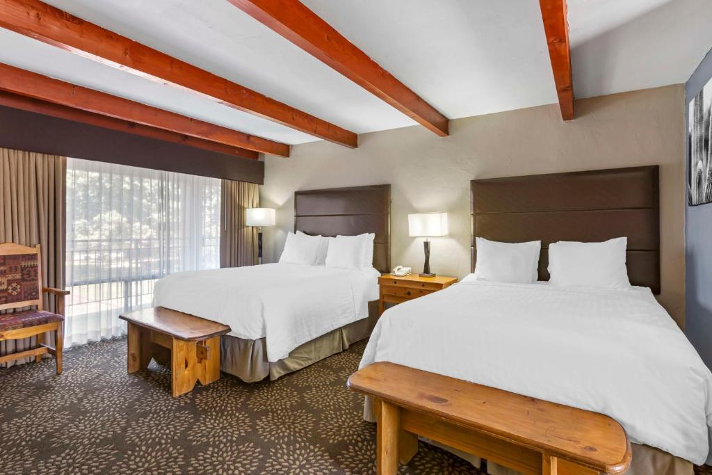 a hotel room with two beds and a window at Best Western Mission Inn in Las Cruces