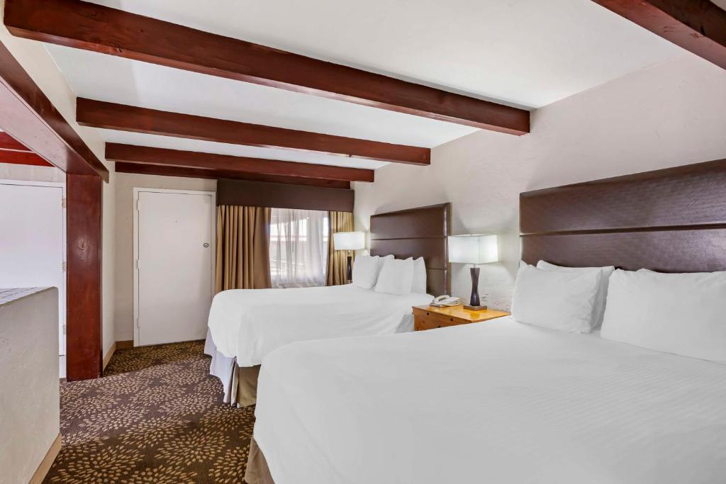 a hotel room with two beds and a window at Best Western Mission Inn in Las Cruces
