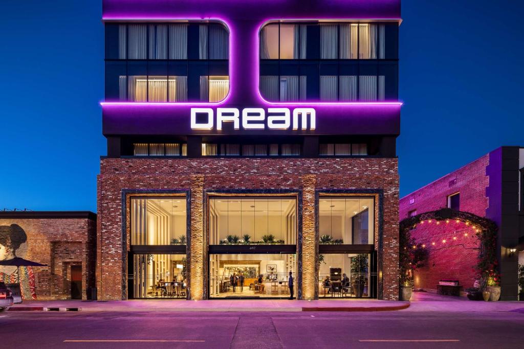 a store front with a neon sign on it at Dream Hollywood, by Hyatt in Los Angeles