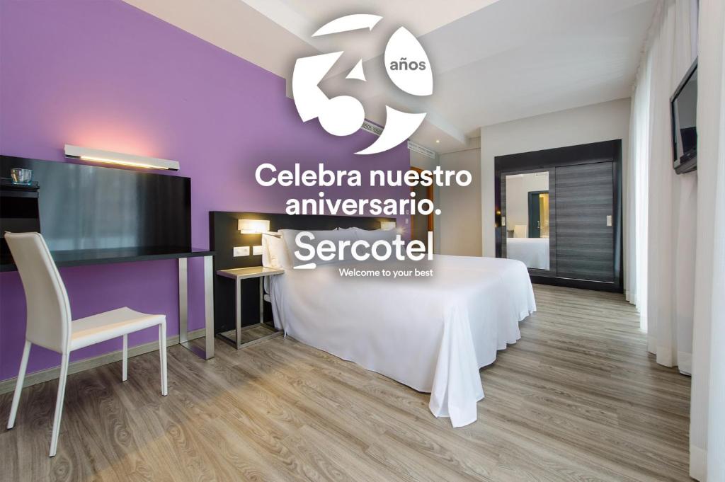a room with a white table and a purple wall at Sercotel Córdoba Medina Azahara in Córdoba