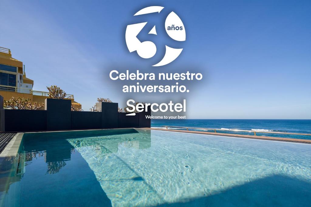 una foto de una piscina frente al océano en Sercotel Playa Canteras en Las Palmas de Gran Canaria