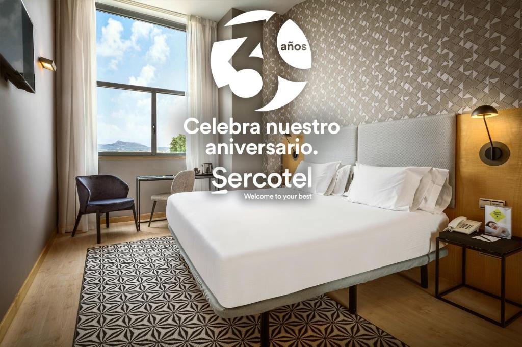 a hotel room with a white bed in a room at Hotel Sercotel Portales in Logroño