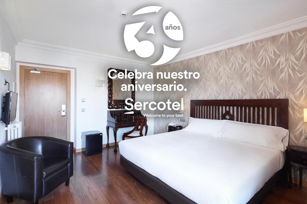 a bedroom with a bed and a sign on the wall at Sercotel Hotel President in Figueres