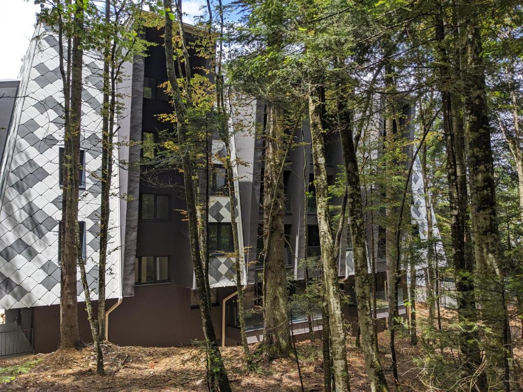 an external view of a building through the trees at Mountain Oasis Bjelasnica in Bjelašnica