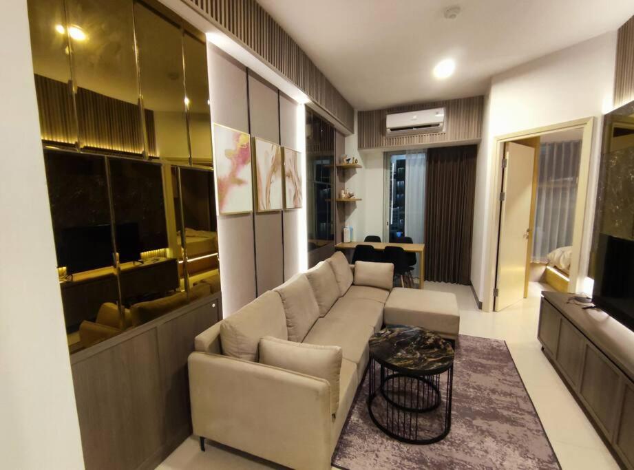 a living room with a couch and a table at Apartment Benson Tower 2 Bed Room by Lavida in Surabaya