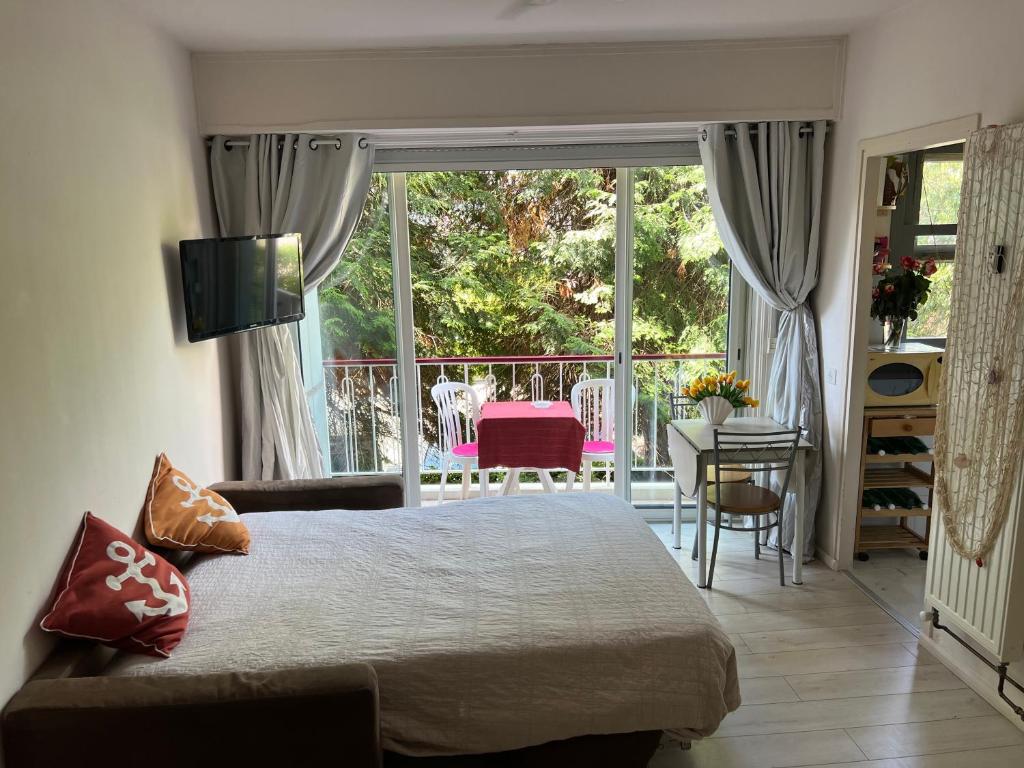 a bedroom with a large bed and a balcony at Cros de Cagnes, apartment with the Best Location in Cagnes-sur-Mer