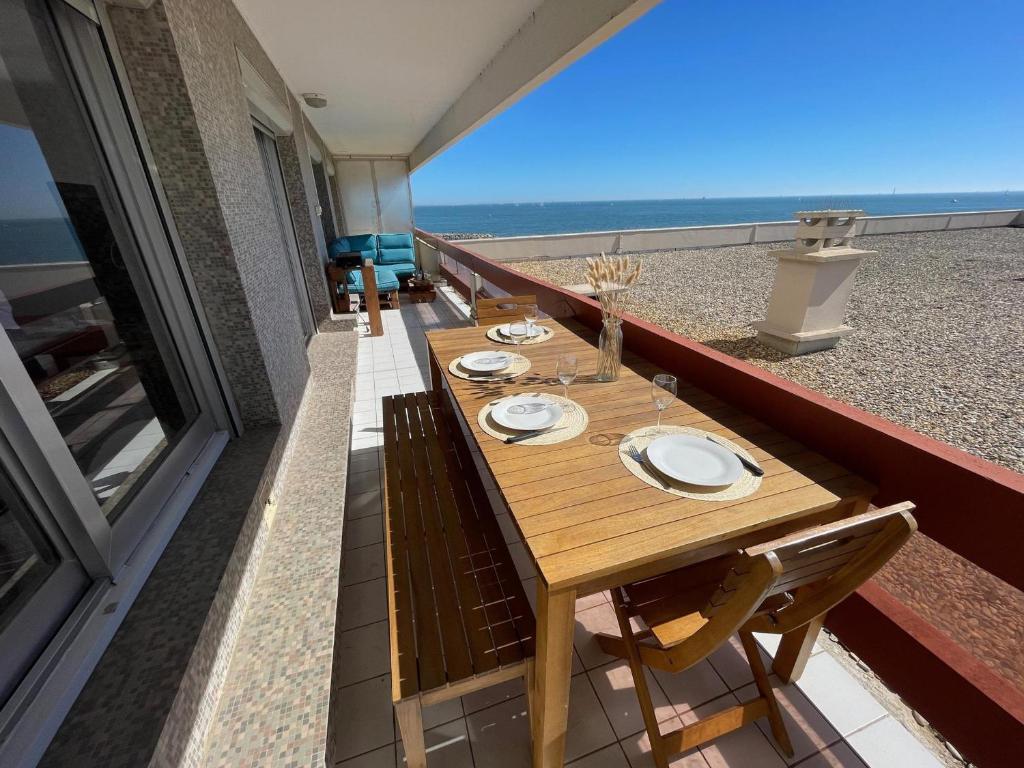 stół na balkonie z widokiem na plażę w obiekcie Joli 3 Pièces rénové avec terrasse, vue mer et ascenseur - FR-1-716-2 w mieście La Grande-Motte