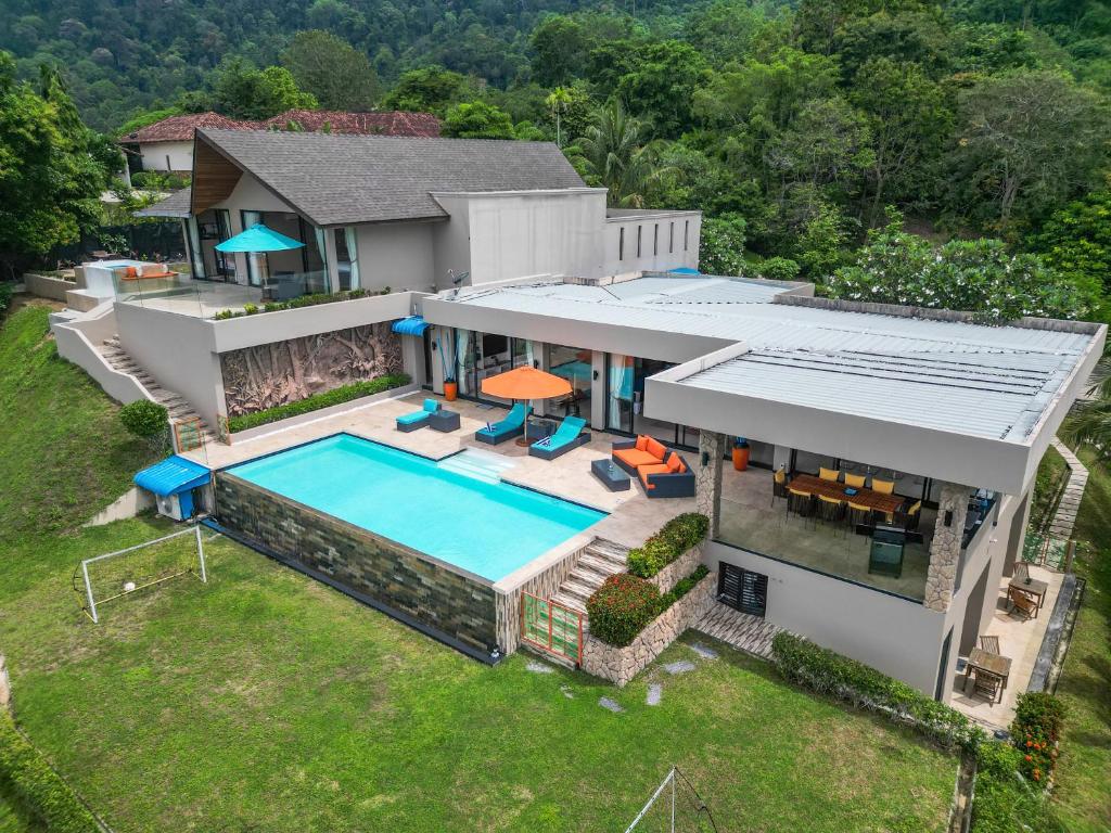 an aerial view of a house with a swimming pool at White Monkey Villa - Private Pool & Jacuzzi in Pantai Cenang