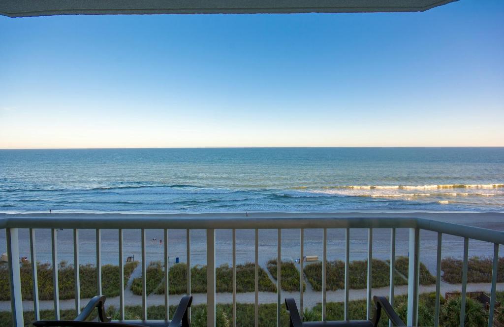 a view of the ocean from the balcony of a condo at The Strand - A Boutique Resort in Myrtle Beach