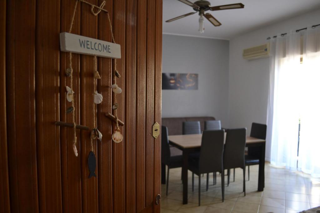 a door to a dining room with a table and chairs at Naxos Sweet Dreams Apartment in Giardini Naxos