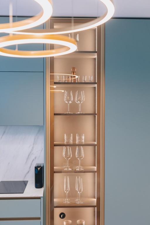a kitchen with a wine rack with wine glasses at Mint & Gold Luxury Suite in Malinska