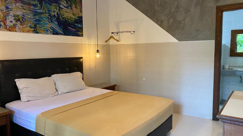 Postel nebo postele na pokoji v ubytování Sandat Hotel Legian