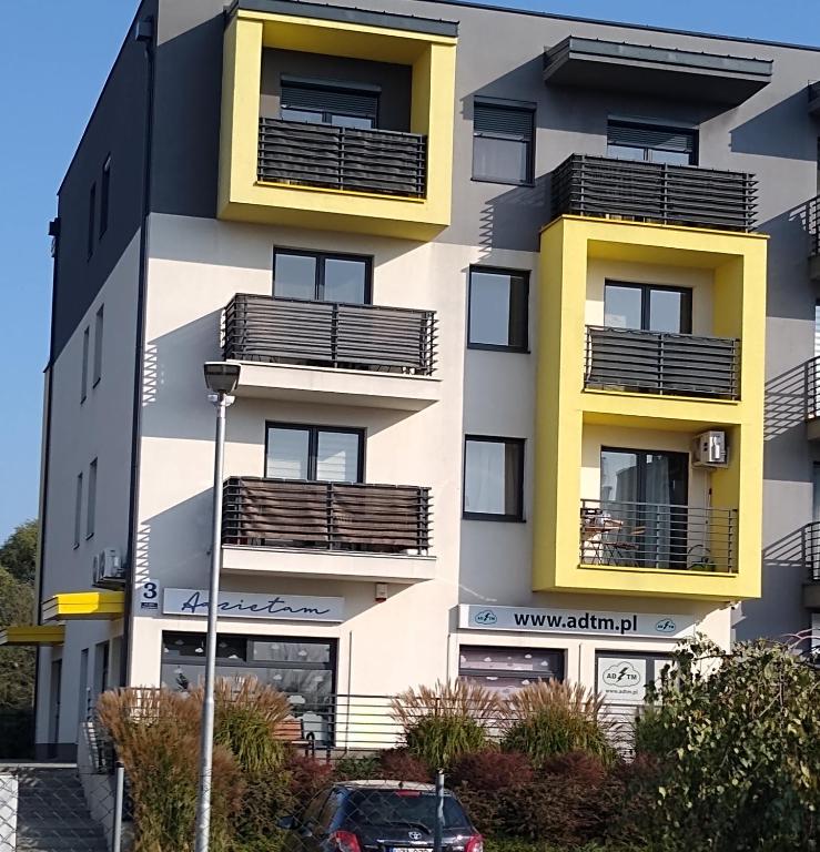 a building with balconies on the side of it at APARTAMENT MARTA in Zamość