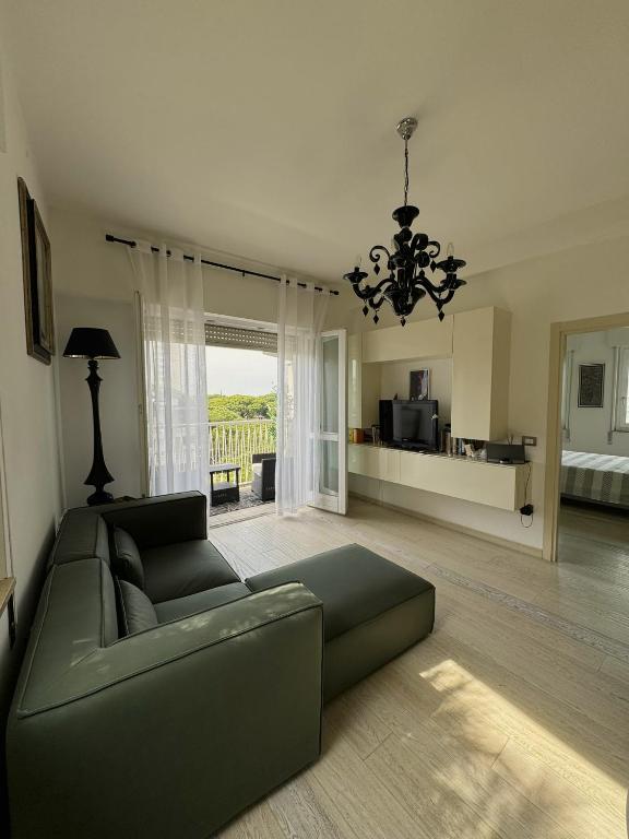 a living room with a couch and a chandelier at Charm in centre, sunset, movida! in Milano Marittima