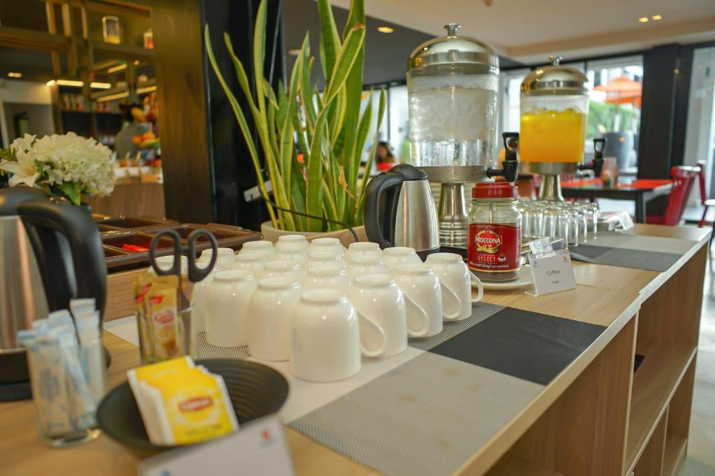 A beverage station with milk jugs, juice dispensers and tea supplies.