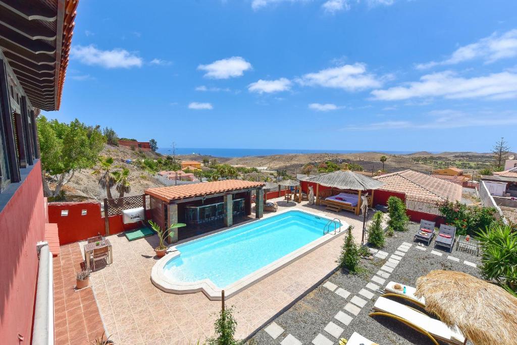 a swimming pool in a yard with a house at Ca'Sita Salobre Pueblo by VillaGranCanaria in San Bartolomé de Tirajana