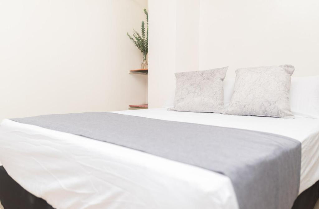 Postel nebo postele na pokoji v ubytování Hotel Conquistadores