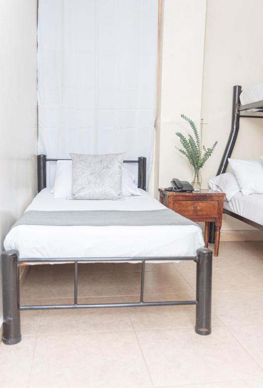 Postel nebo postele na pokoji v ubytování Hotel Conquistadores
