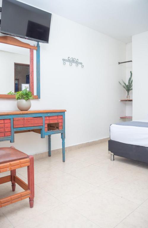 Postel nebo postele na pokoji v ubytování Hotel Conquistadores