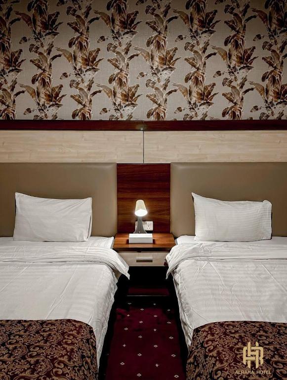 Postel nebo postele na pokoji v ubytování Al Rahaa Furnished Aparthotel