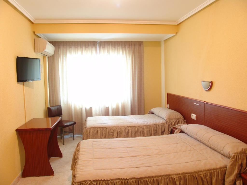 מיטה או מיטות בחדר ב-Hostal Athlanta