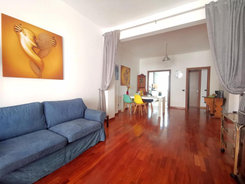 a living room with a blue couch and a table at Cipro Home in Rome
