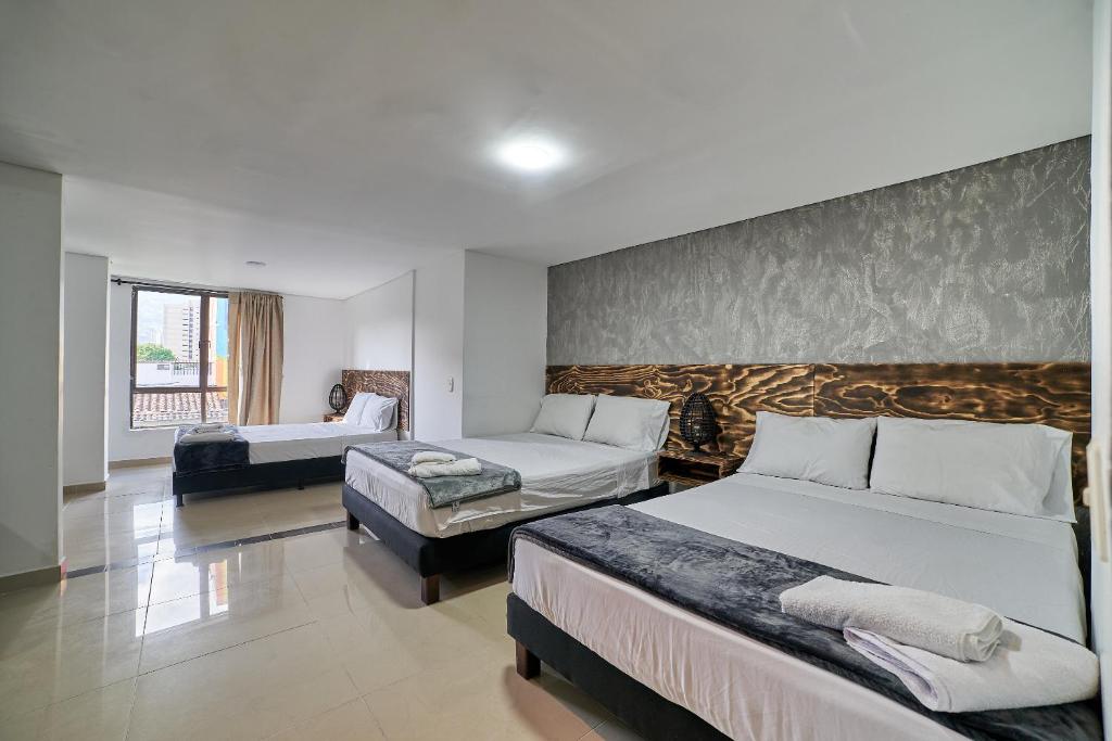 Postel nebo postele na pokoji v ubytování Hotel Express Medellin FARUM