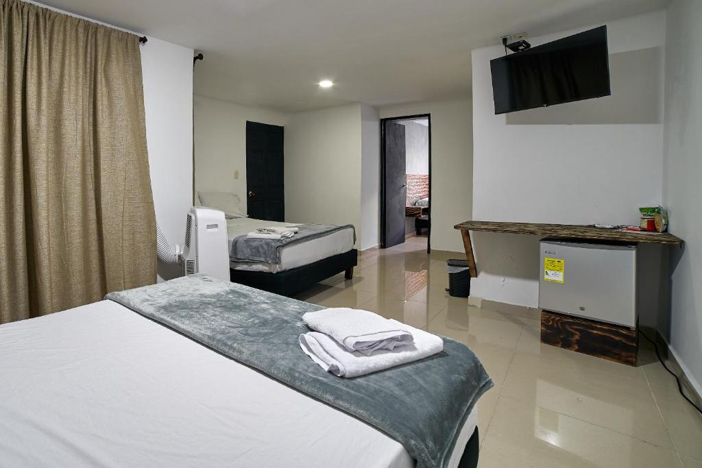 Postel nebo postele na pokoji v ubytování Hotel Express Medellin FARUM