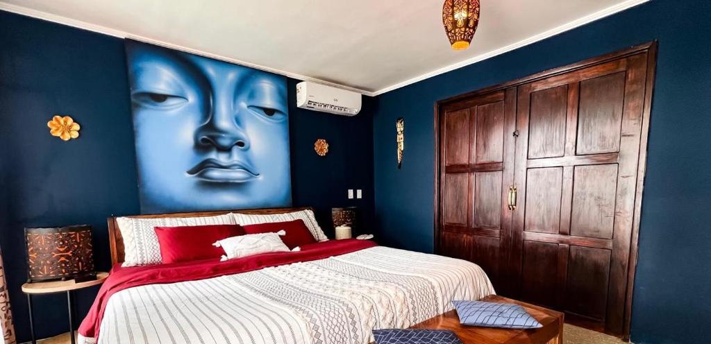 a bedroom with a bed with a face painted on the wall at ORHO HOTEL BOUTIQUE PANAMA Tocumen Airport free shuttle highway round trip 15 minuts in Tocumen