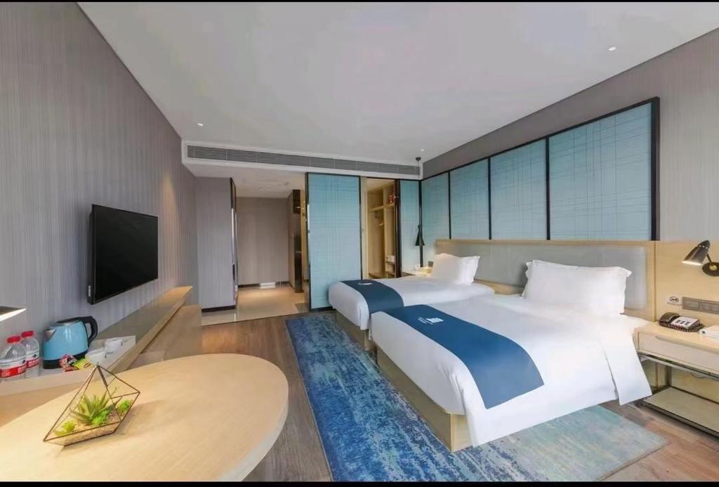 Postel nebo postele na pokoji v ubytování Echarm Hotel Wuhan Hanyang Wangjiawan Sixin Avenue Metro Station