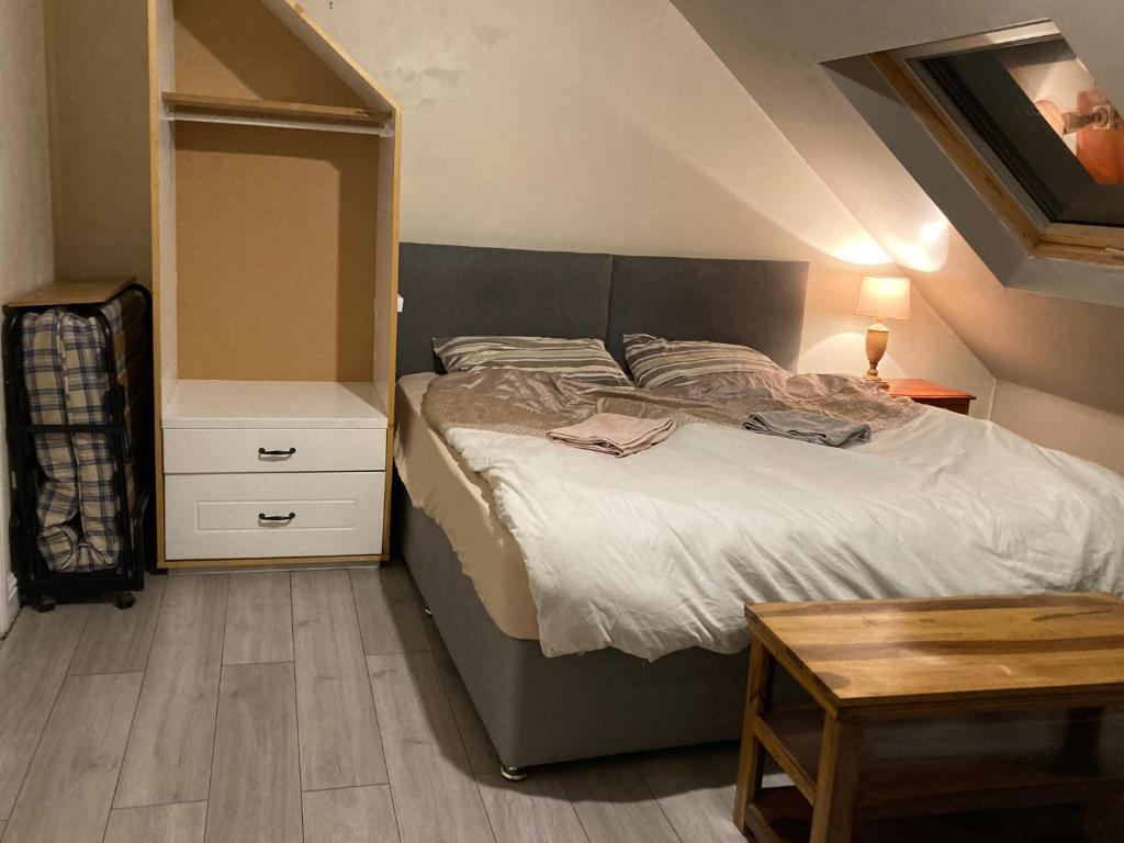a bedroom with a large bed and a table at BFamily-Jacks Court in Stalybridge