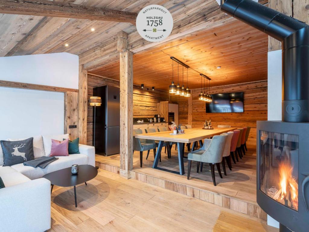a dining room and living room with a fireplace at NATURPARKGUT - Apartment HOLZGAU1758 in Holzgau