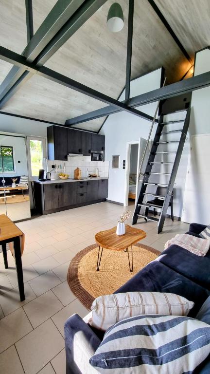 a living room with a couch and a table and a kitchen at Black&White in Mrągowo