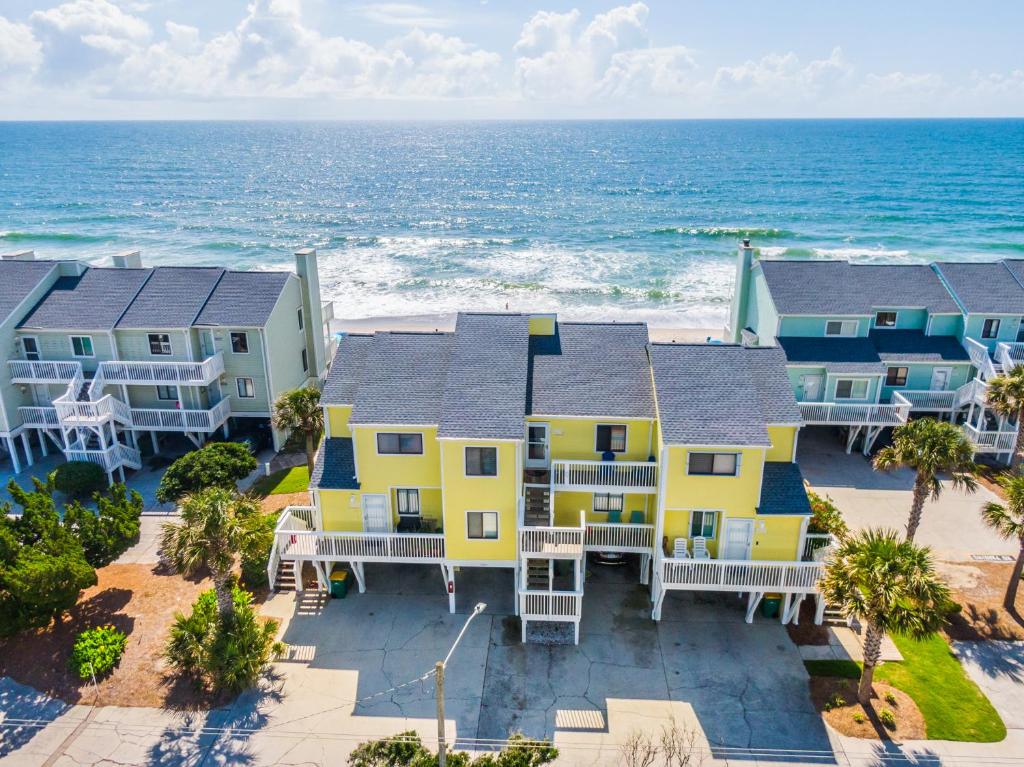 an aerial view of a row of houses on the beach at Ocean Dunes 1402 in Kure Beach