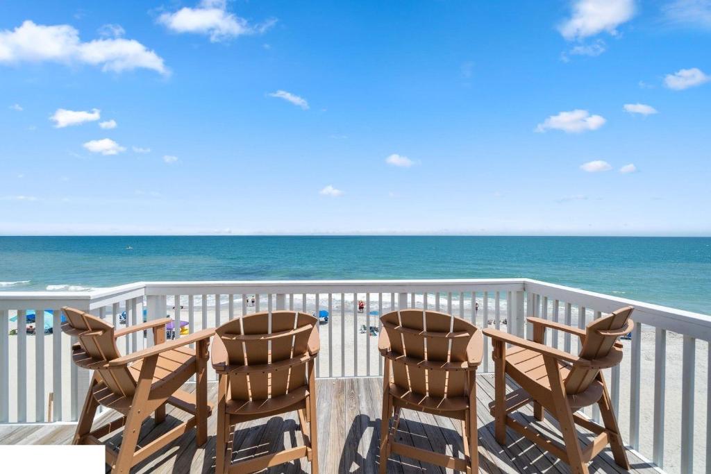a balcony with two chairs and the ocean at Ocean Dunes 2112 in Kure Beach