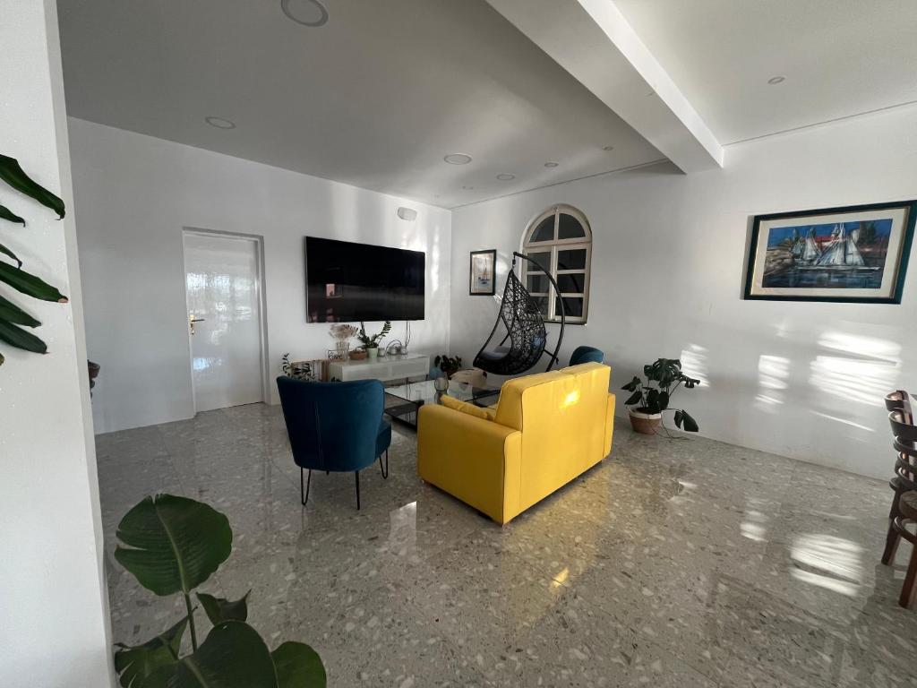 a living room with a yellow couch and a table at Dela in Hvar