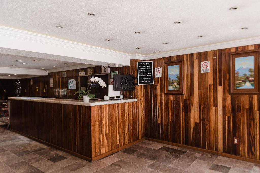 un bar en un restaurante con paredes revestidas de madera en Hotel Rex, en Toluca