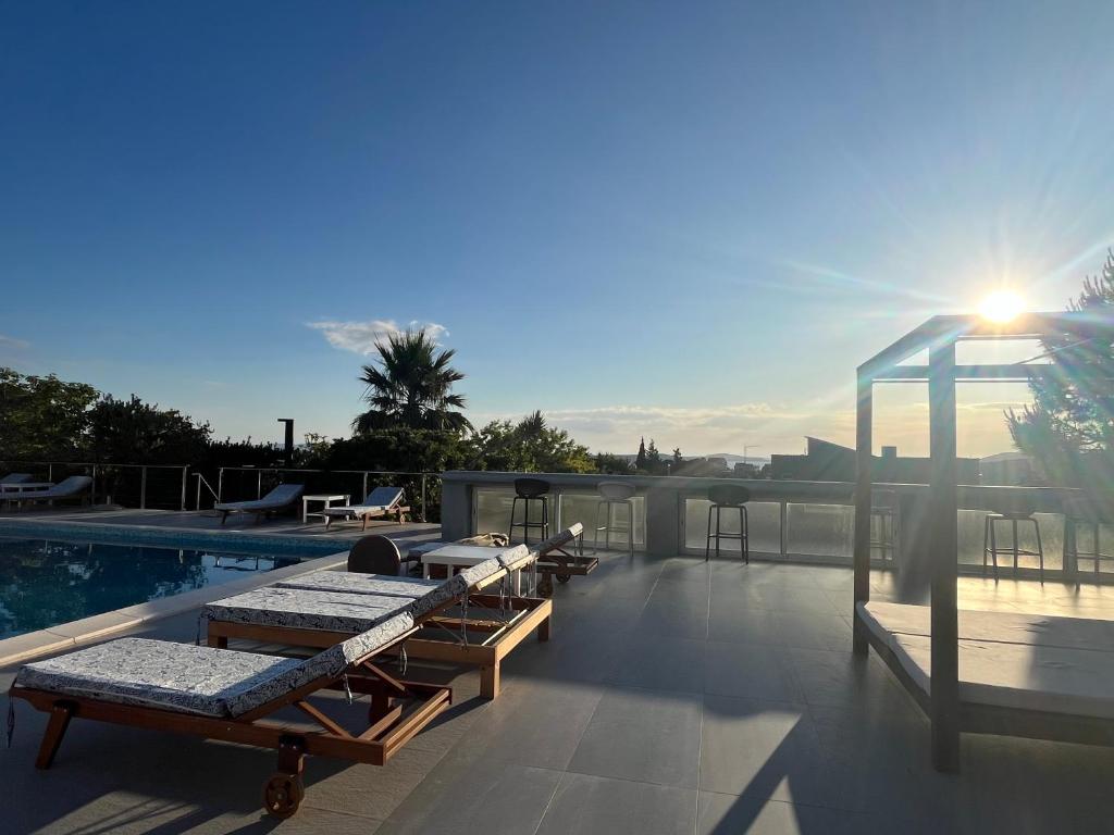 a swimming pool with chaise lounges on top of a house at Dela in Hvar
