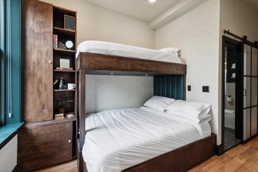 a bedroom with two bunk beds with white sheets at Society Hill Hotel in Philadelphia