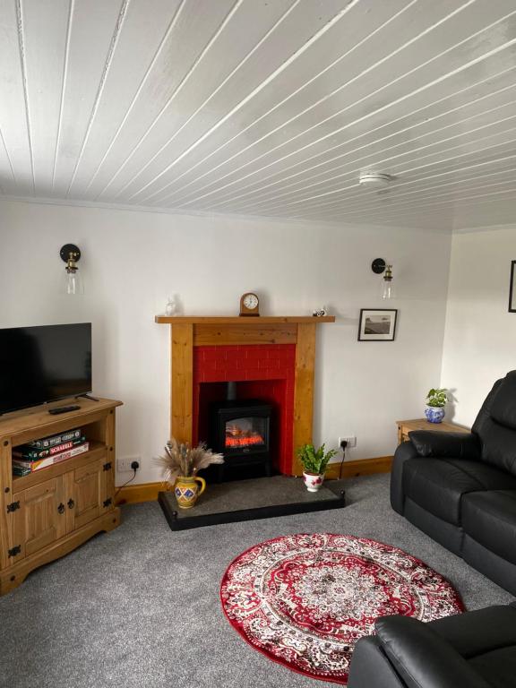 TV a/nebo společenská místnost v ubytování Cnoc Ruaraidh Cottage