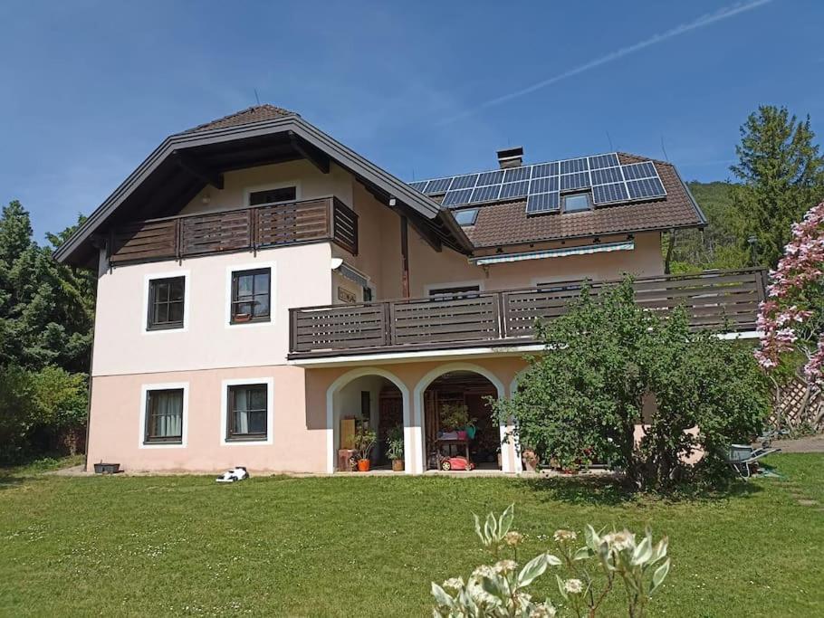 a large house with solar panels on the roof at Großzügiges Landhaus im Grünen in Oberpiesting