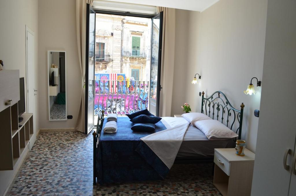 Posteľ alebo postele v izbe v ubytovaní Appartamenti Piazza Duomo Acireale